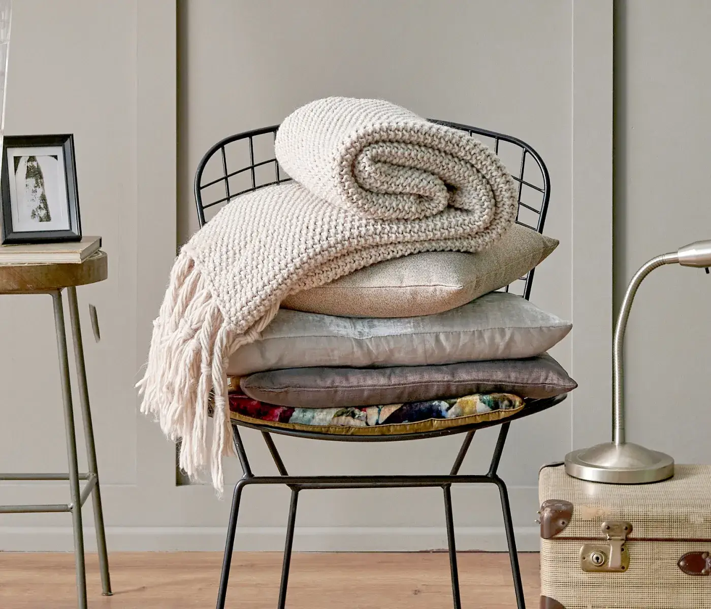 a stack of pillows sitting on top of a chair