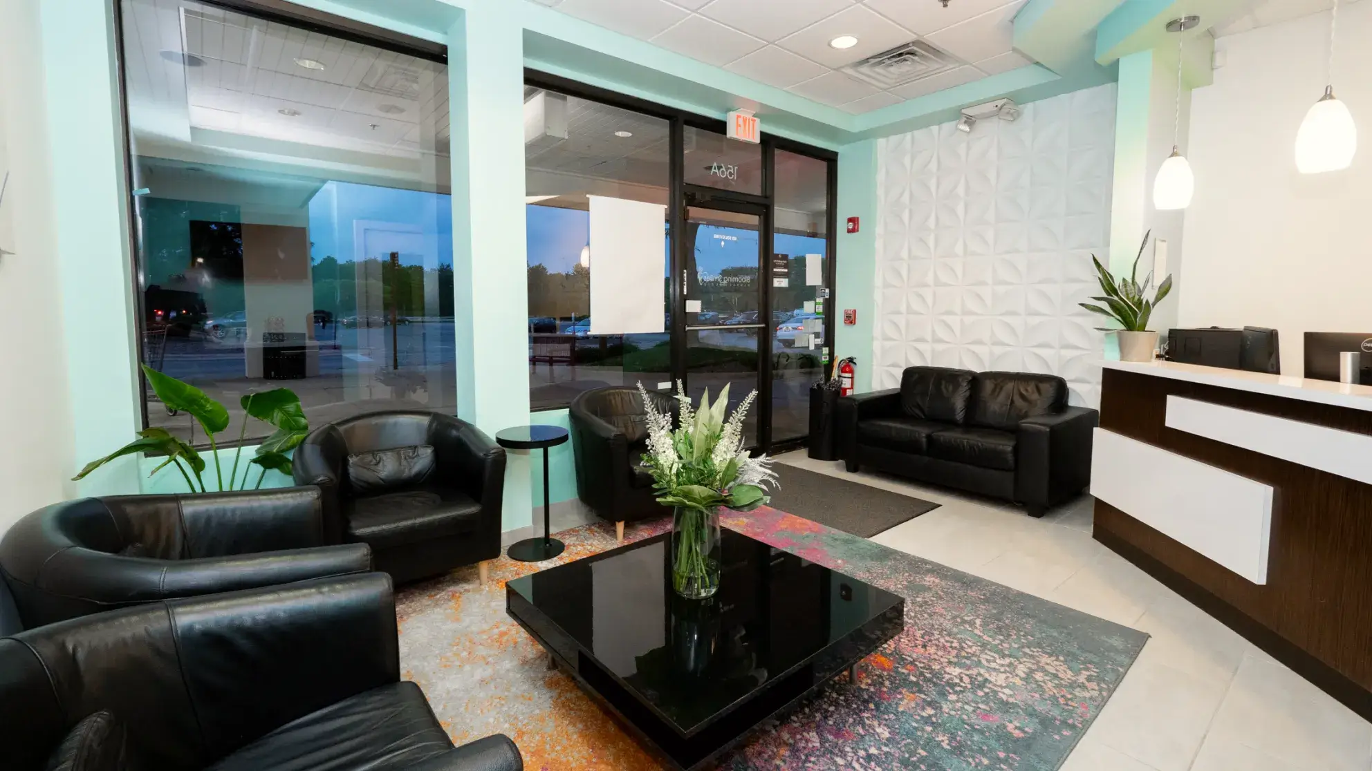 a lobby with black leather chairs and a black coffee table
