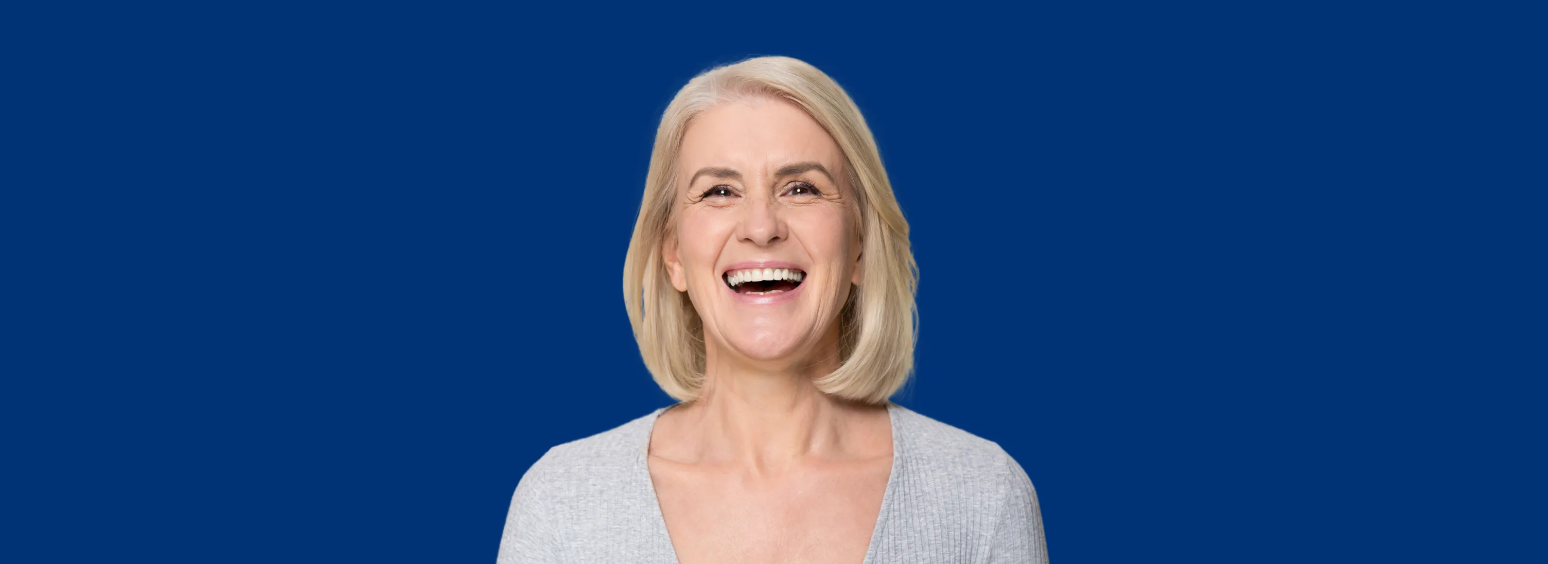 a woman smiling with a blue background