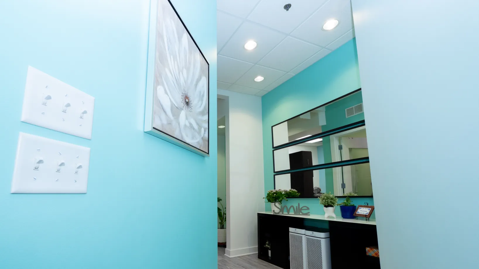 a bathroom with a blue wall and a mirror