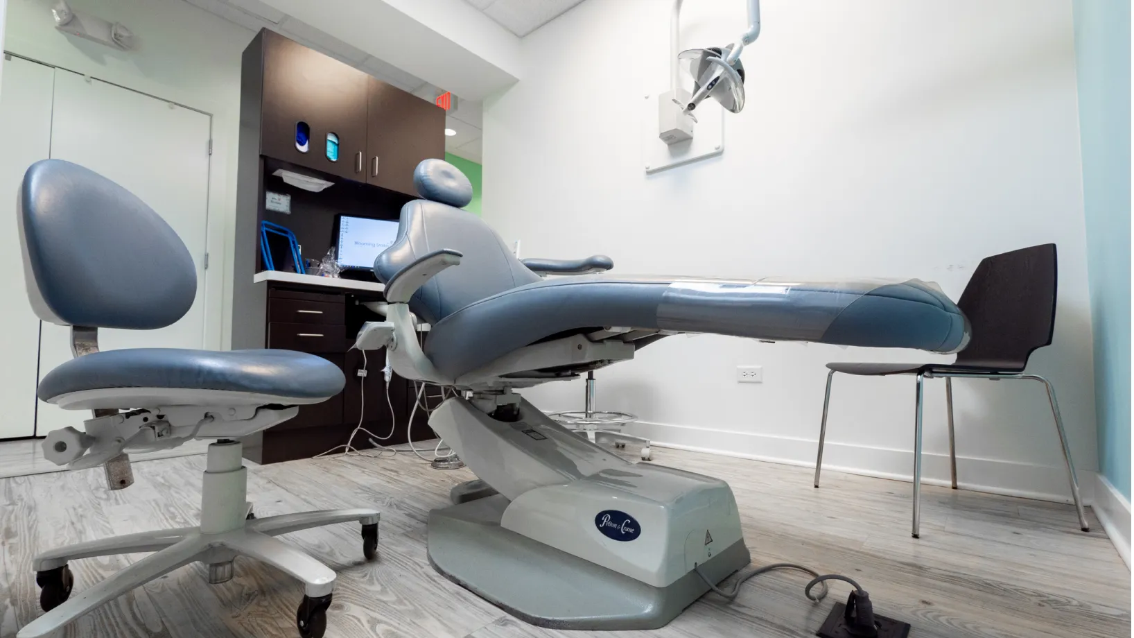 a dental chair in a room with a computer