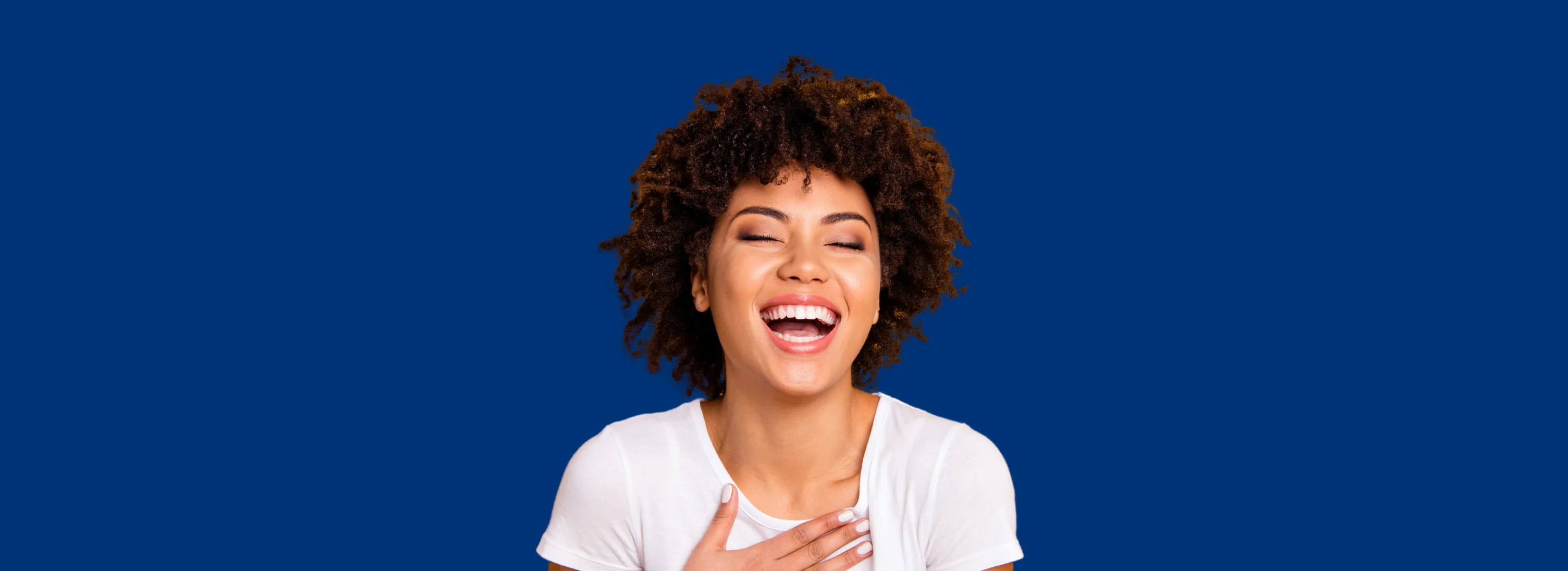 a woman with her mouth open with her hands together