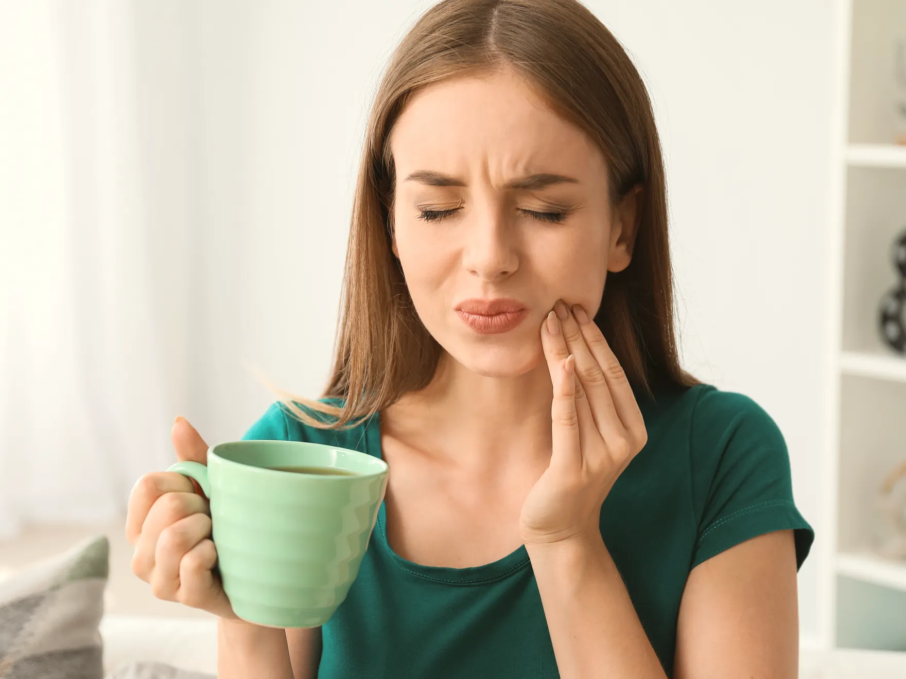 a woman holding a cup of coffee in her hands